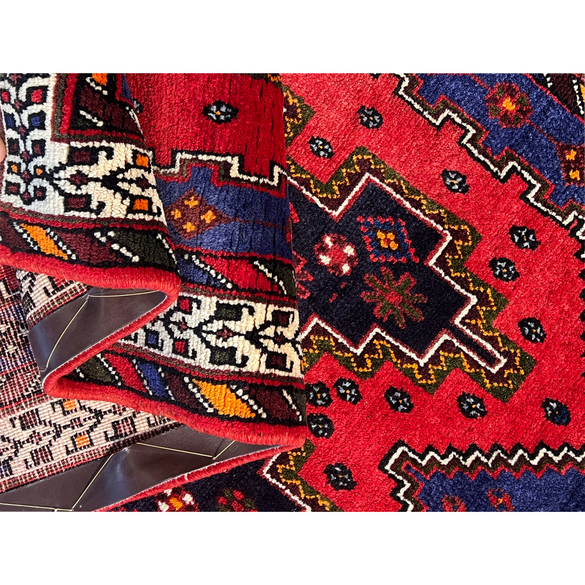Rug runner view with a red central motif, dark blue, and colorful decorative squares