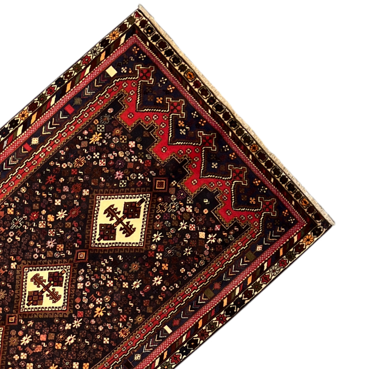 Sirjan carpet detail: central medallions in light beige on dark brown, border visible