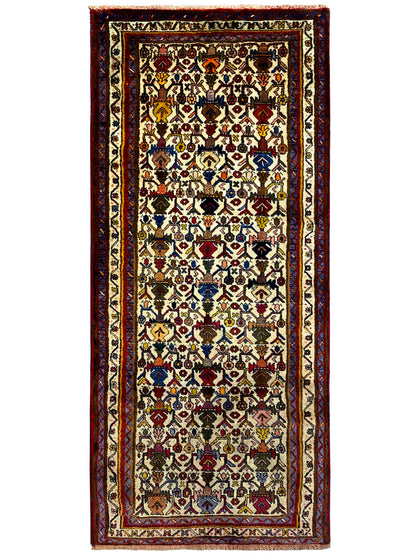 Rectangular Sirjan rug with a dense ornamental design, red borders, and a light background