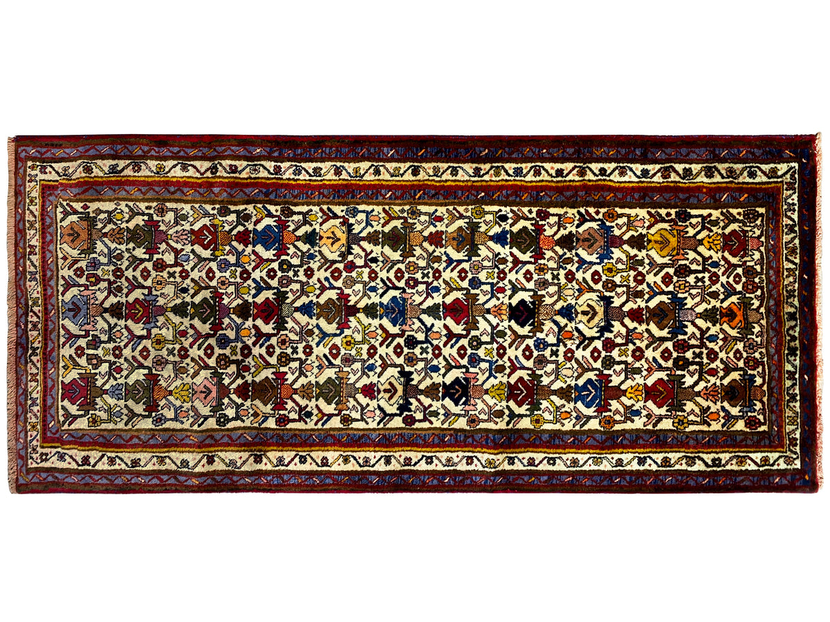 Sirjan rug in landscape format: central ornamental field with colorful diamonds and border