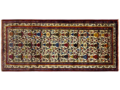 Sirjan rug in landscape format: central ornamental field with colorful diamonds and border