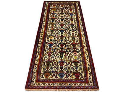 Sirjan rug laid flat, multicolored pattern with red and gold edging
