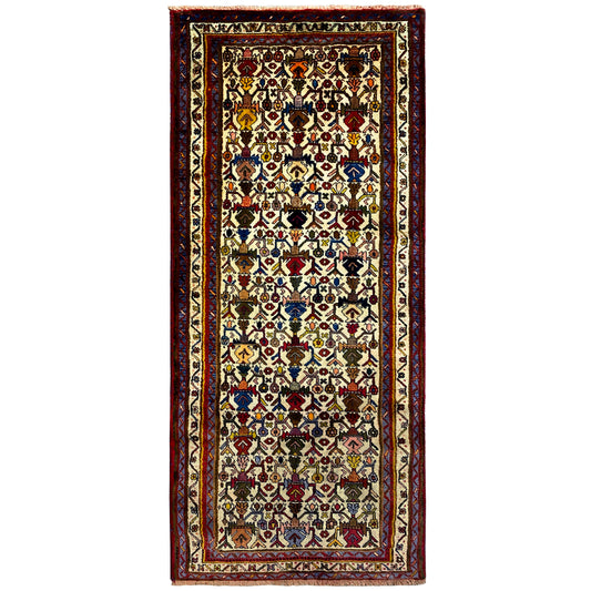 Sirjan rug with a border in red and a multicolored ornamental pattern on a light background
