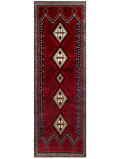 Full view: red runner rug with a vertical pattern in cream and dark blue