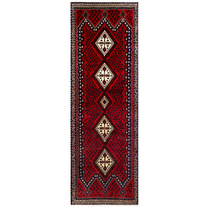 Red rectangular runner rug with vertical diamond motifs and a border