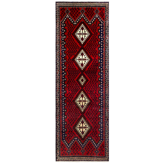 Red rectangular runner rug with vertical diamond motifs and a border