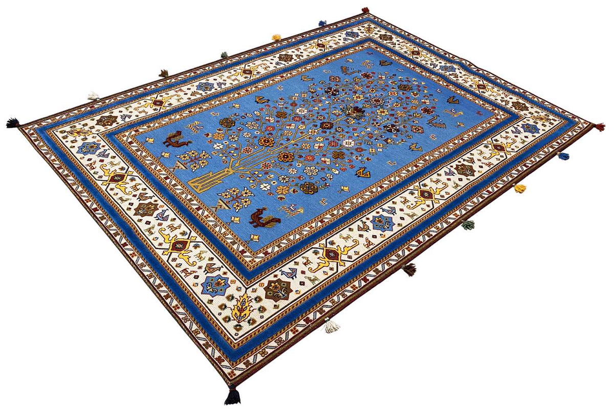 Blue Oriental rug viewed from above, large border with ornaments and corner fringes