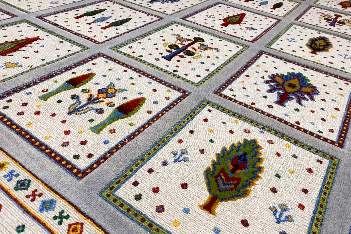 Soumak rug detail view: colorful motifs in tiles on a beige background