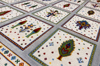 Soumak rug detail view: colorful motifs in tiles on a beige background