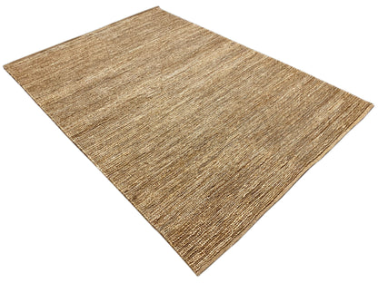 Rectangular sand-beige mottled rug, photographed diagonally