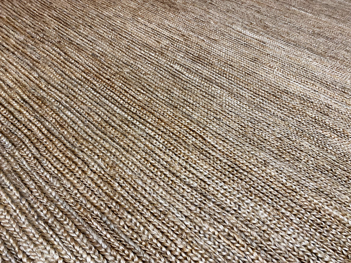 Close-up view of the carpet surface with fine horizontal and vertical lines