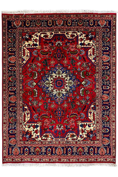 Red carpet with large ornamental fields, blue border, and central medallion