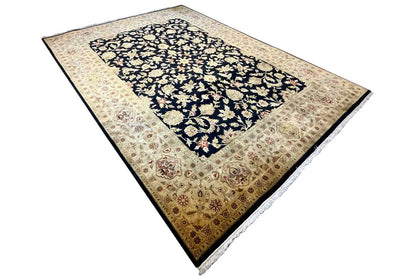 Rug viewed at an angle, dark blue medallion with a beige decorative border