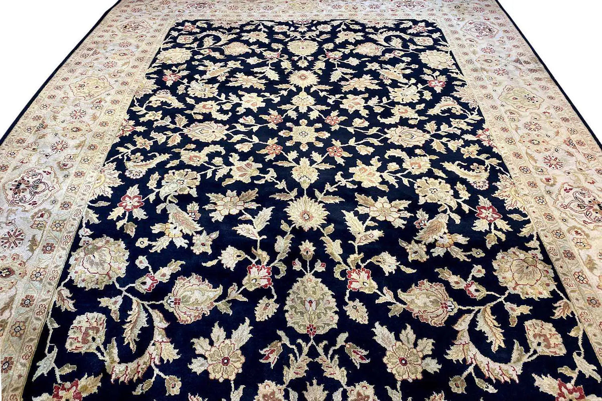 Carpet view from above: dark blue floral ornament with a cream-colored border