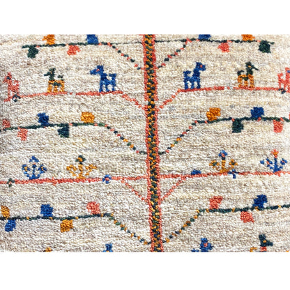 Close-up: beige cushion 40x40 cm with colorful embroidery and center seam