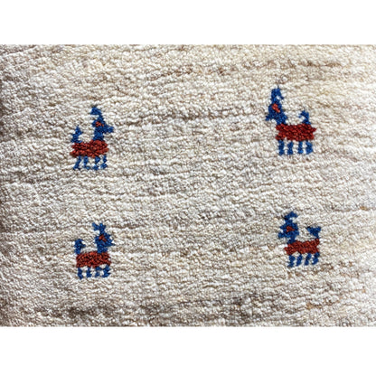 Wool cushion 40x40 cm: close-up, beige wool fabric with a blue-and-red embroidered figure