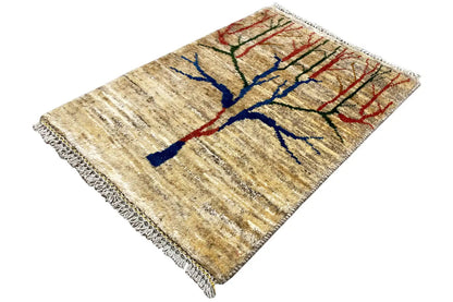 Gabbeh rug, angled view, tree motif in blue, red, and green on beige