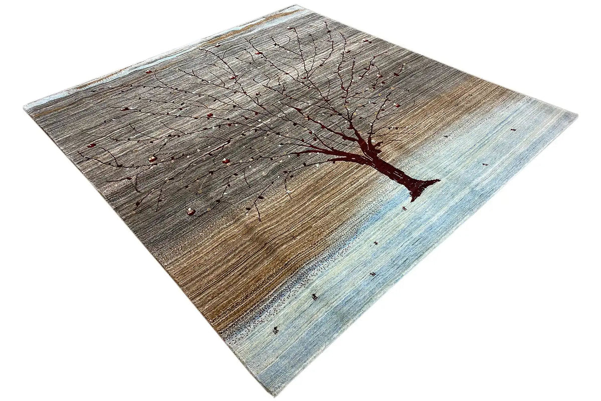 Gabbeh rug with a large tree emblem, gray-brown, light blue stripe, rectangular.