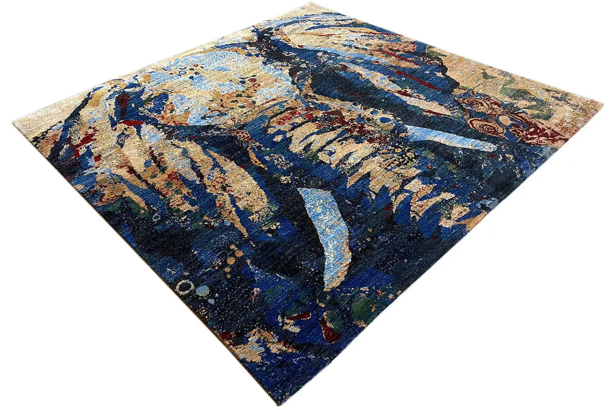 Gabbeh Lori rug with an abstract blue and beige pattern, viewed from above at an angle