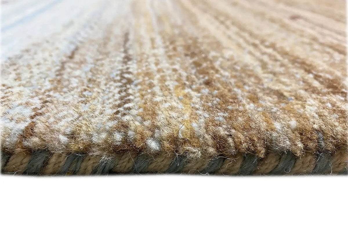 Gabbeh rug: pile detail at the edge, brown-beige yarn fuzz, side edge.