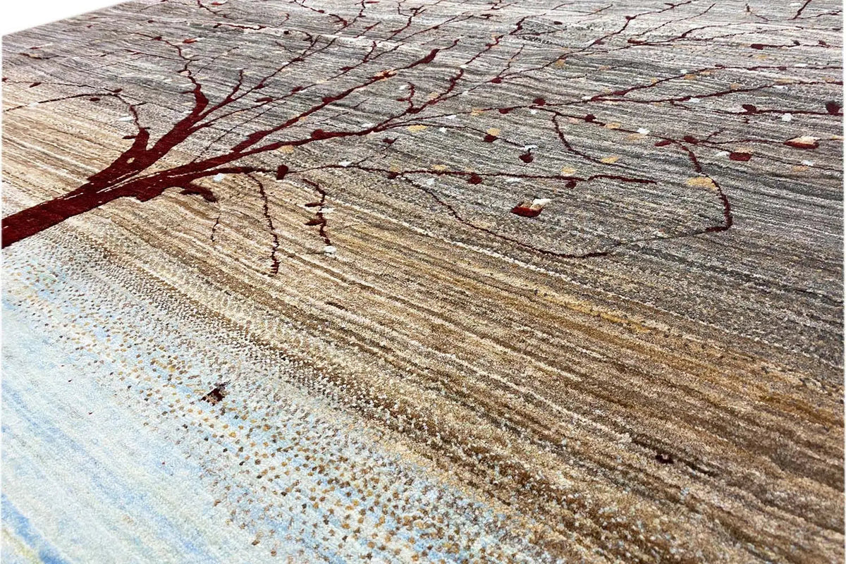 Close-up of a Gabbeh rug: red branches and dots on a gray-brown background.