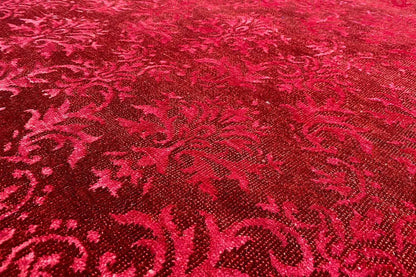 Close-up: red carpet with an ornamental pattern and dense, fine texture