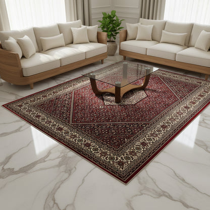 Rectangular red carpet with a delicate ornamental pattern and surrounding decorative border