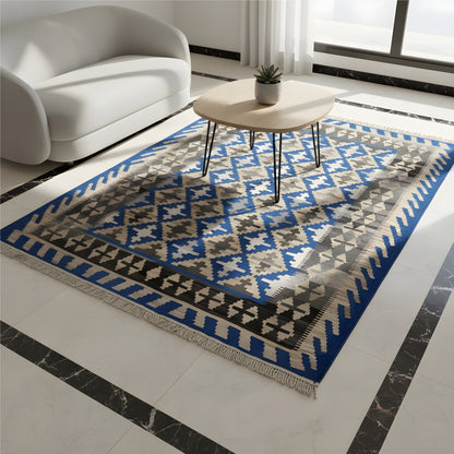 Kilim rug in a living room: rectangular blue and beige pattern, fringes all around