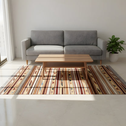 Kilim rug in the living room beneath the coffee table, striped design in warm colors