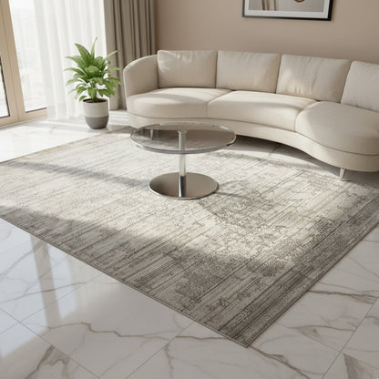 Gray designer rug in the living room, featuring an all-over vintage pattern and border line