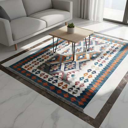 Kilim rug for the living area with geometric patterns in blue, orange, and cream, fringes