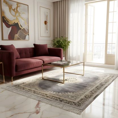 Medallion rug with a divided dark gray border and fringes along the edge