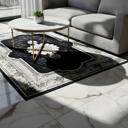 Black 160x230 cm rug with an ornamental pattern on a light floor in front of a sofa