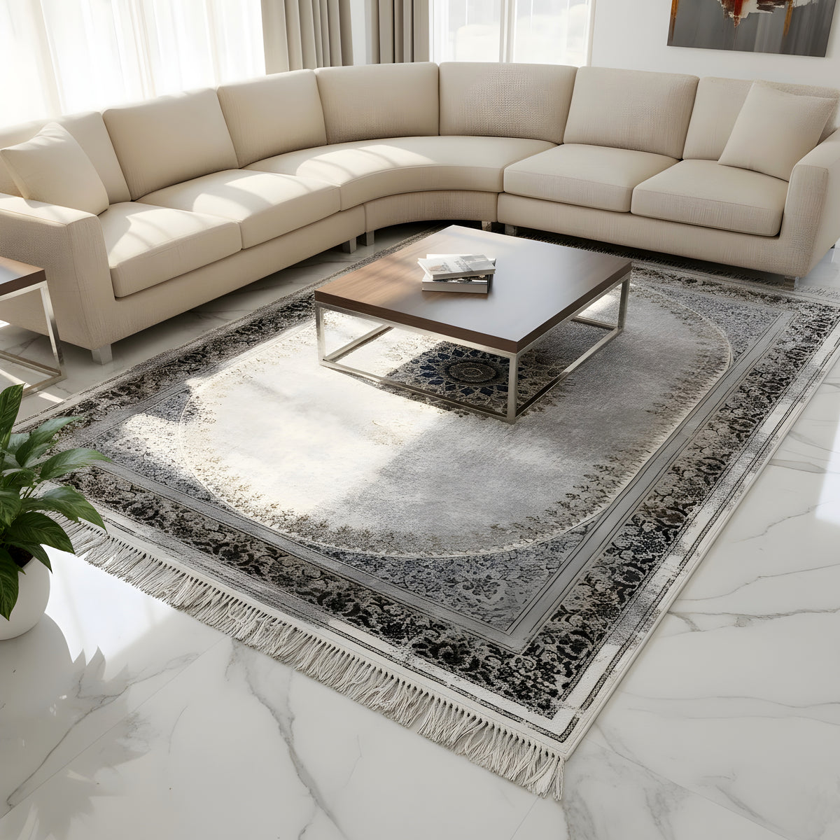 Vintage rug in the living area, silver-gray with decorative border, medallion, and long fringes
