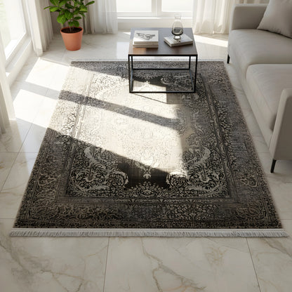 Rectangular dark gray/beige rug with a Baroque ornamental pattern, laid folded