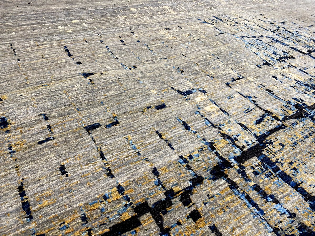 Hand-knotted rug with an abstract pattern in light gray and dark blue