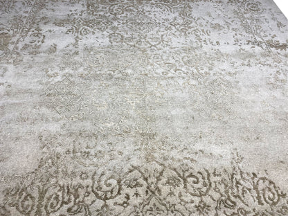 Close-up of a designer rug: light beige surface with subtle vintage-style ornamental texture