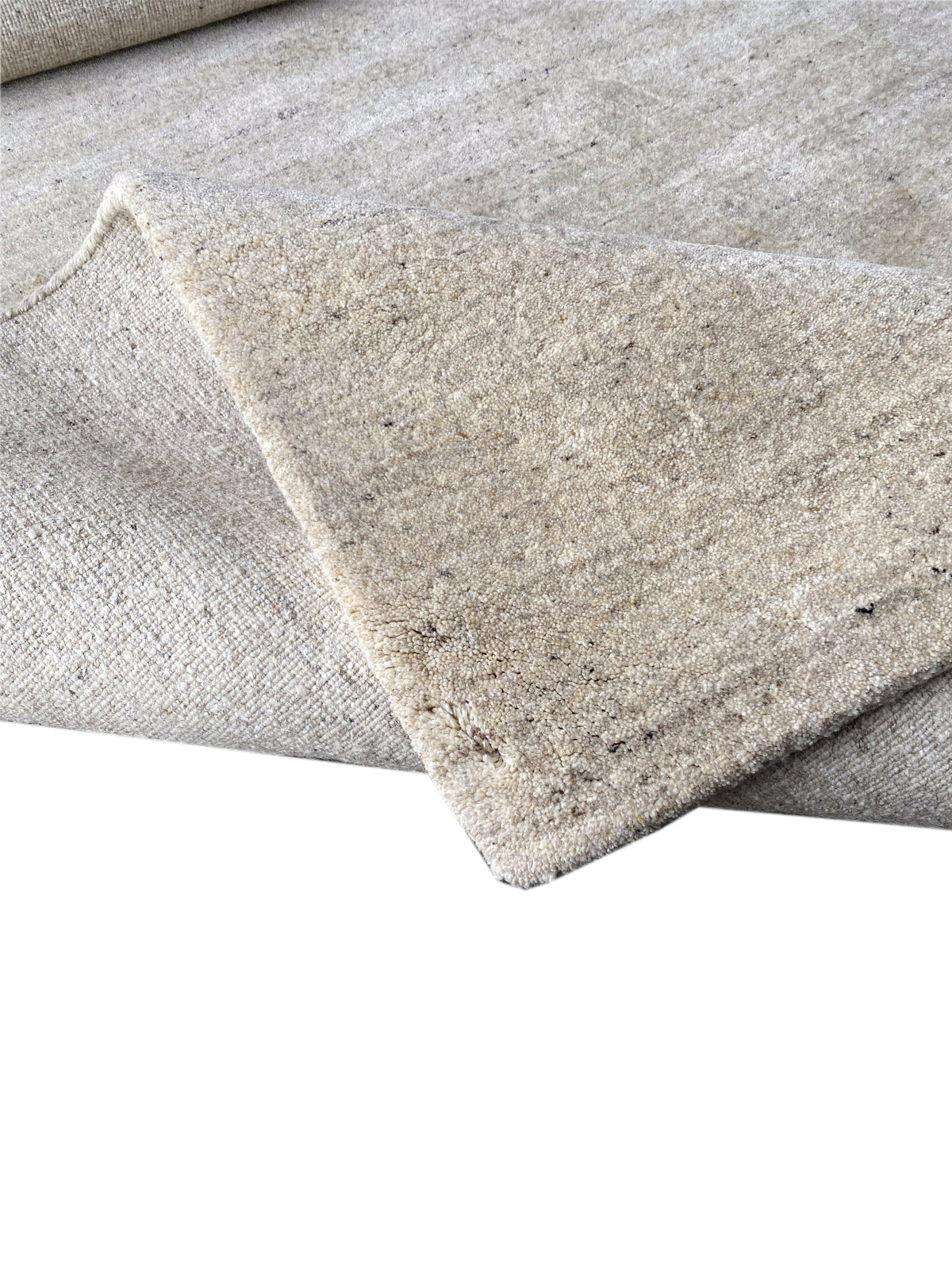 Beige carpet with a rounded corner and a visible selvedge along the edge