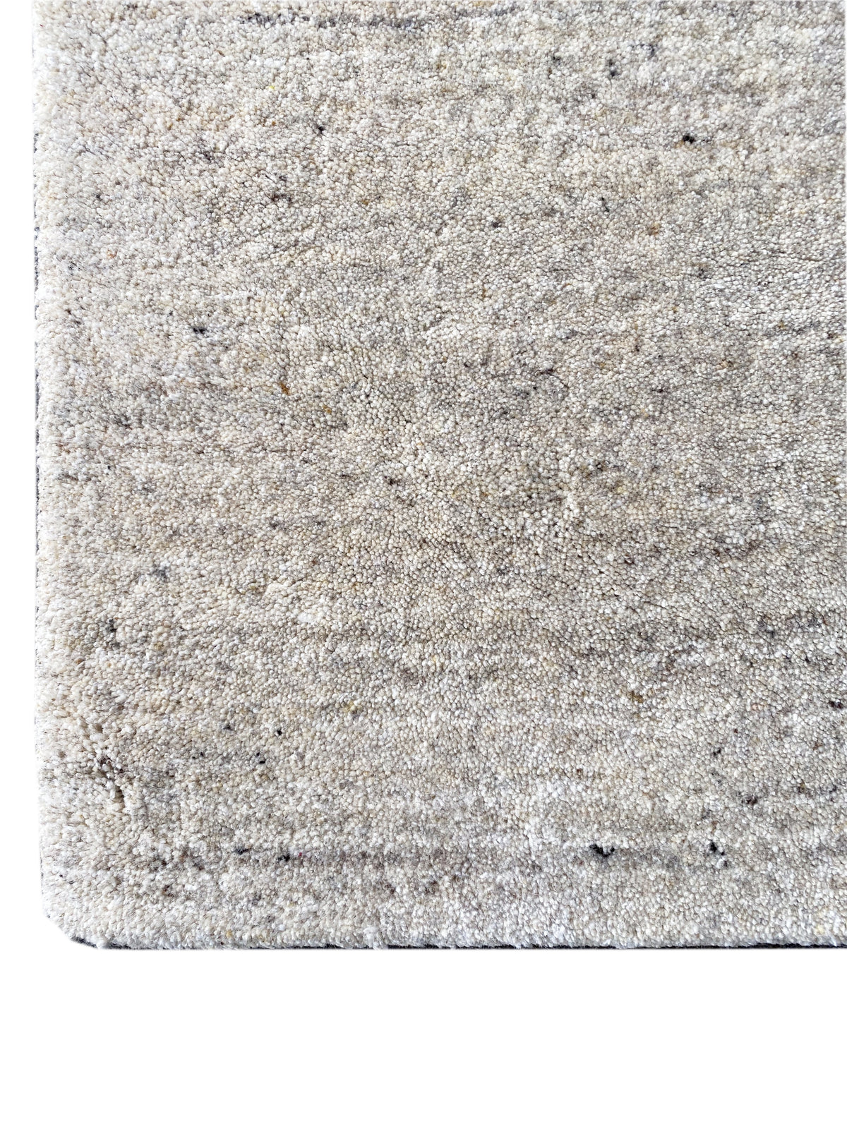 Beige carpet with a thick, mottled surface and a clean edge at the finish