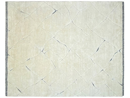 Rectangular cream rug with a delicate linear pattern and blue border
