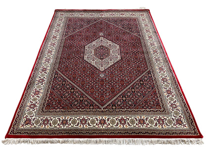 Red carpet with a square medallion, surrounding border, and fringe