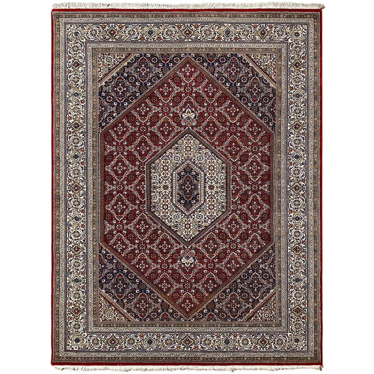 Carpet with a red background, blue border pattern, and light medallion in the center