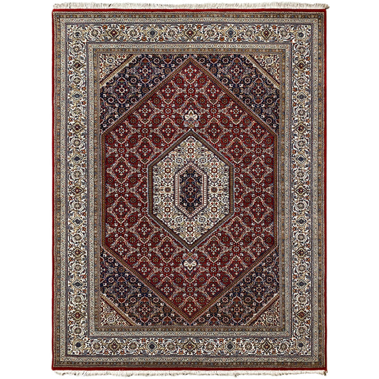 Carpet with a red background, blue border pattern, and light medallion in the center