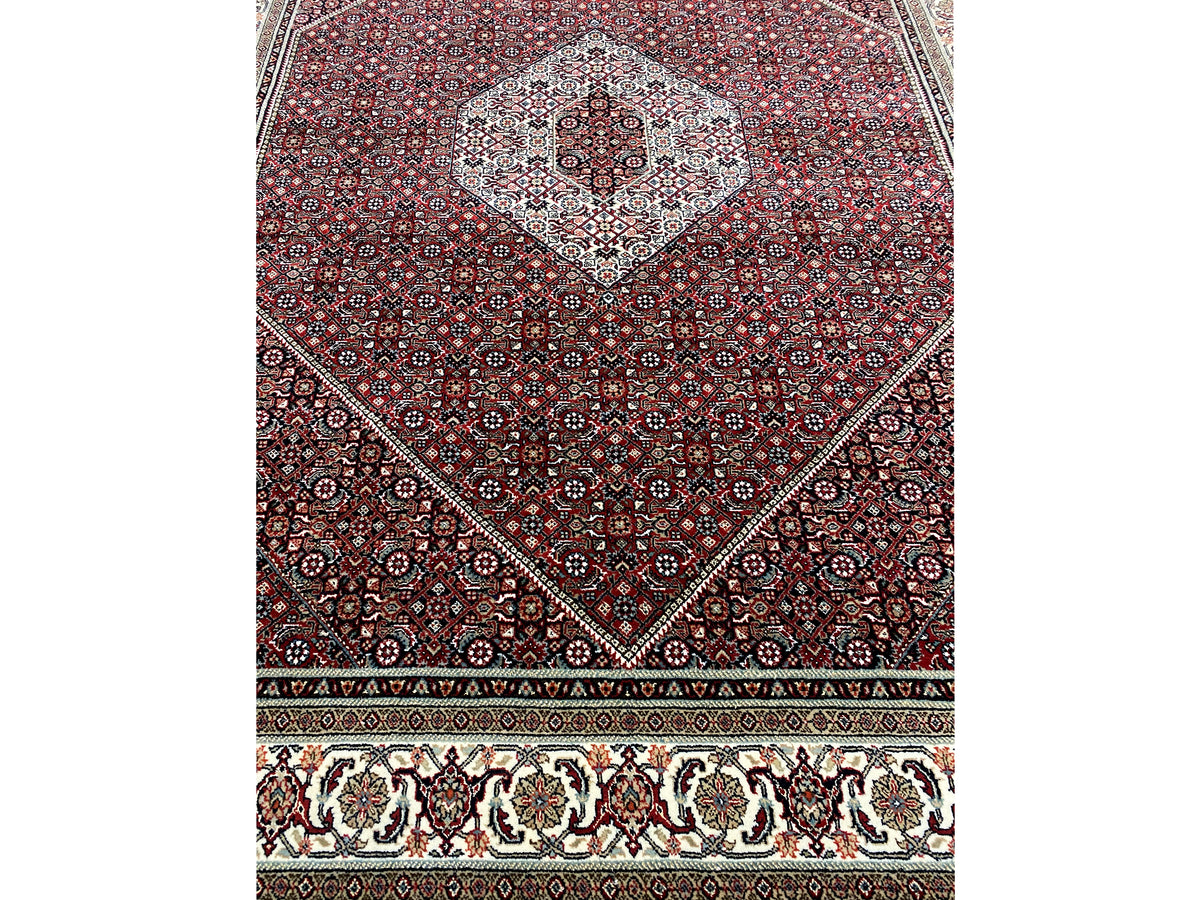 Bidjar rug with a round medallion, reddish-brown ground, and cream-colored border band