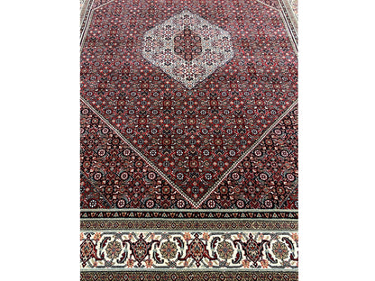 Bidjar rug with a round medallion, reddish-brown ground, and cream-colored border band