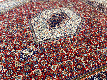 Close-up of the carpet pattern: red field with numerous floral ornaments and corner motifs