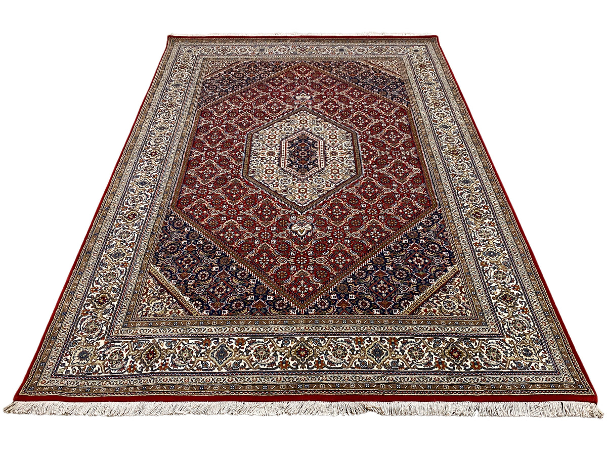 Rug with a red central medallion, wide border, and dark blue frame