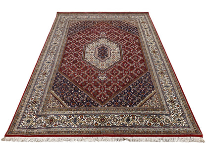 Rug with a red central medallion, wide border, and dark blue frame