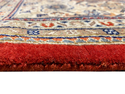 Rug edge with fringe and reddish-brown pile; multicolored decorative border beneath