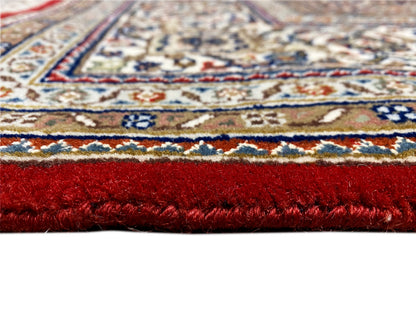 Carpet with a red pile, multicolored ornaments, and a visible patterned border